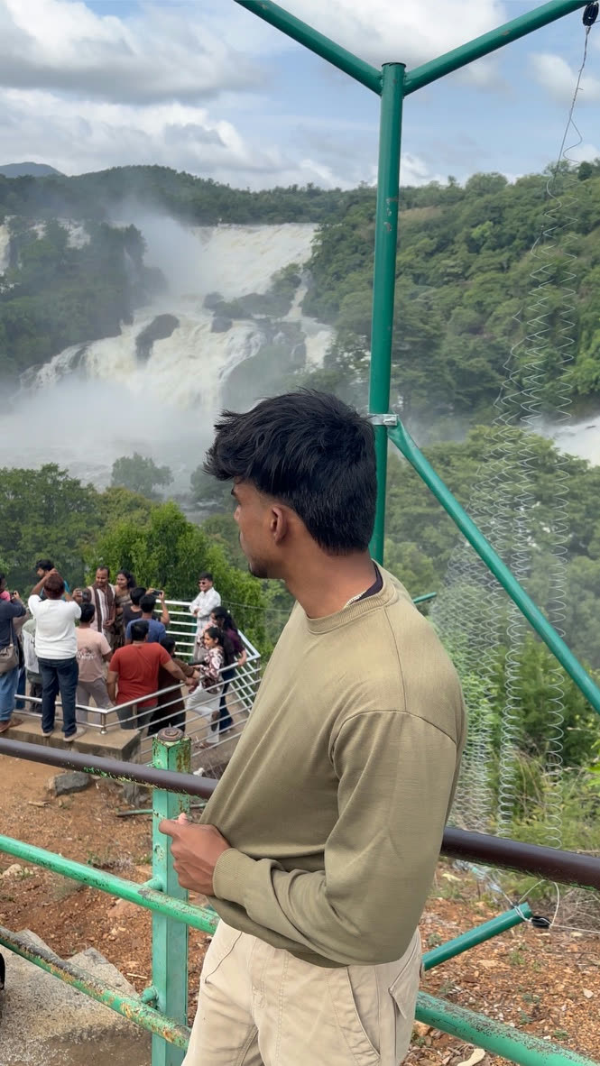 Vaibhav looking out at a huge misty waterfall